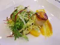 Carmelized Day Boat Scallop, Frisée and Micro Greens in an Orange Saffron Reduction