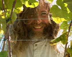 Didier Dagueneau surrounded by grape leaves