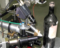 A particle accelerator authenticating the glass of a vintage wine bottle